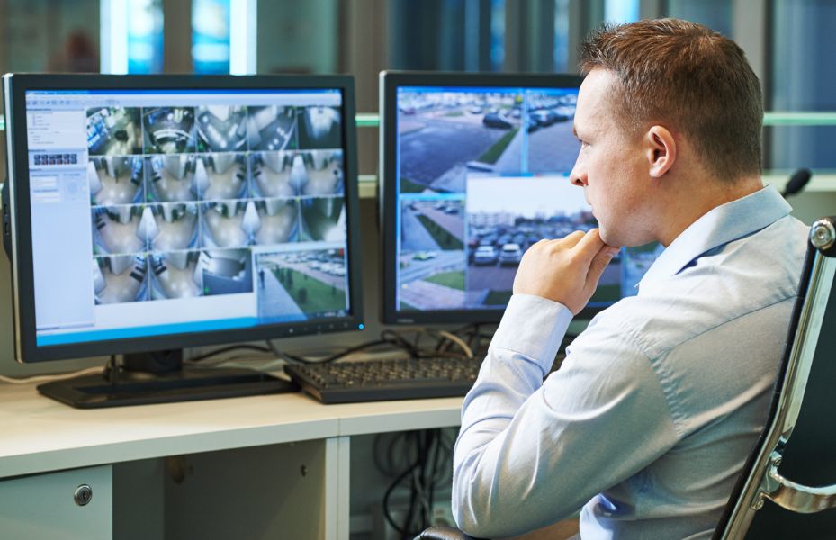 Man monitoring security alarms